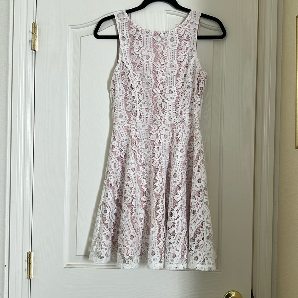 Sweet sleeveless short dress with cream lace and peach lining. Women size Small.